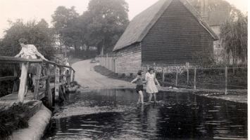 An image of two girls playing in the ford, the date is unkwown.